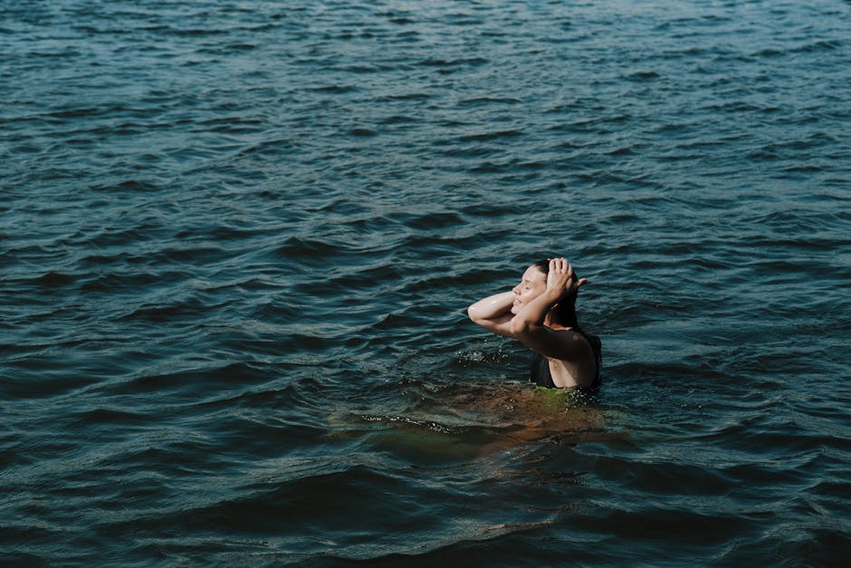 Person breathing deeply with closed eyes in a tranquil setting